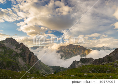 Last warm sunlight on alpine valley 30572001