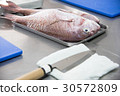 Fresh big fish for cooking with knife in kitchen 30572809