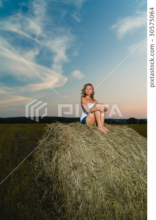 Young sexy blonde posing on a haystack Young sexy blonde posing on a haystack 30575064