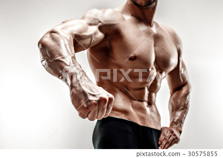 Handsome muscular bodybuilder demonstrates his Handsome muscular bodybuilder demonstrates his 30575855