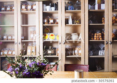 Interior of cafe with sweet stuff in cupboards 30579261