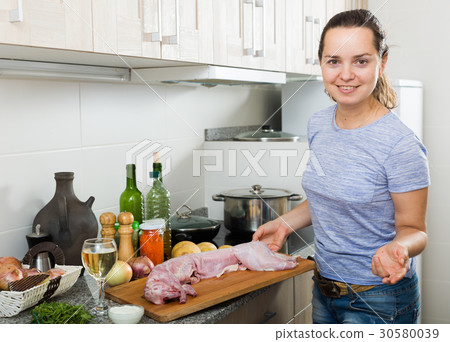 woman cooking rabbit woman cooking rabbit 30580039