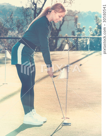 Female golf player getting ready to hit ball 30580541