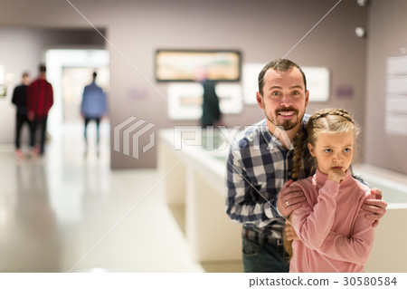 glad father and daughter exploring expositions in museum glad father and daughter exploring expositions in museum 30580584