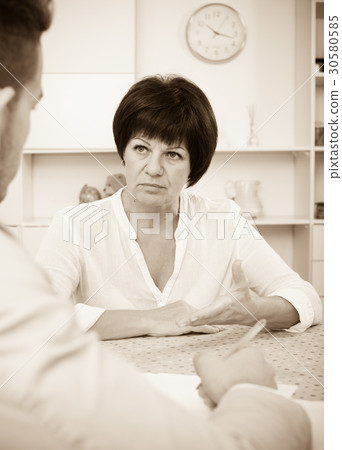 Employer discusses with future worker 30580585