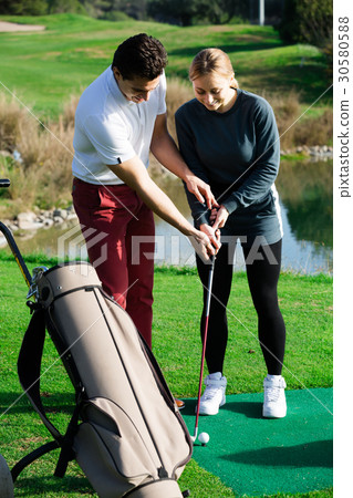 Golf coach explains the basics of a golfer hitting the ball Golf coach explains the basics of a golfer hitting the ball 30580588