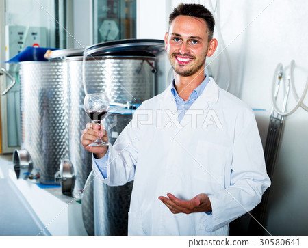 worker holding glass of wine 30580641