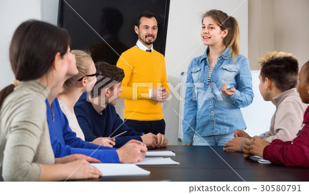 Female student answering teacher’s question at writing board Female student answering teacher’s question at writing board 30580791