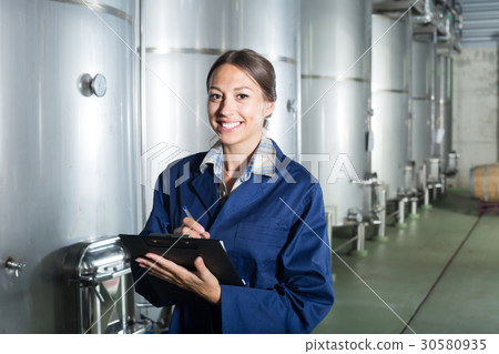 Smiling woman standing with cardboard 30580935