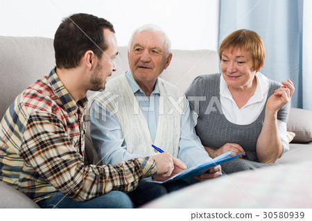 Elderly couple and insurance agent 30580939
