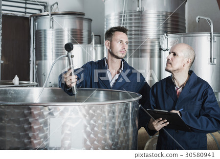 Two male employees at winery. 30580941