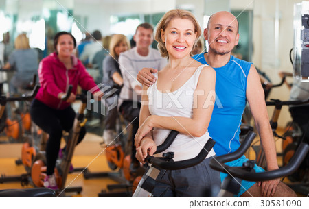 Elderly couple exercising in gym Elderly couple exercising in gym 30581090