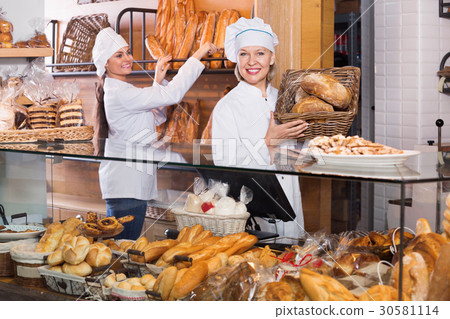 Portrait of friendly cheerful women at bakery display Portrait of friendly cheerful women at bakery display 30581114