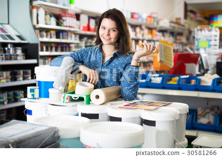 Adult girl is purchasing tools for house improvements Adult girl is purchasing tools for house improvements 30581266
