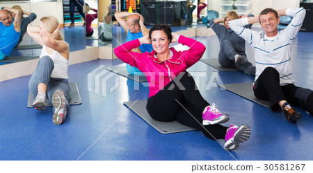 Adults doing pilates routine Adults doing pilates routine 30581267