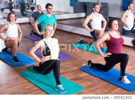 people exercising in dance hall 30581303