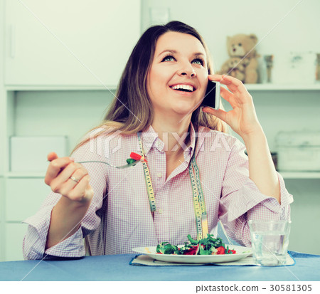 Girl eating salad Girl eating salad 30581305