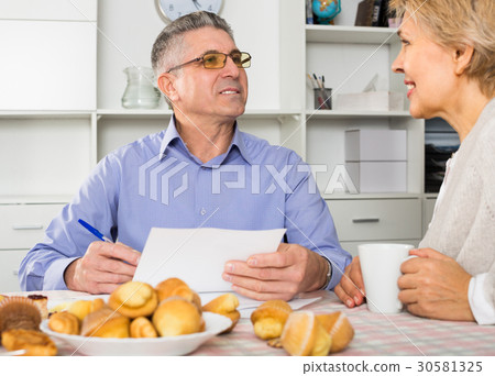 Man and woman are discussing and studying important contract 30581325
