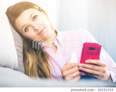 Woman checking her phone and taking selfies 30581354