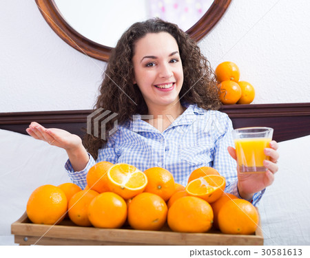 Young woman with orange juice and fruits Young woman with orange juice and fruits 30581613