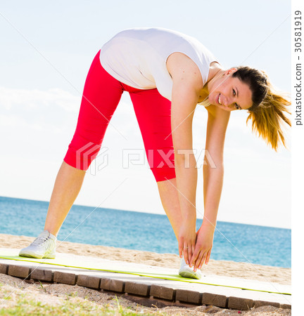 Woman doing yoga standing 30581919
