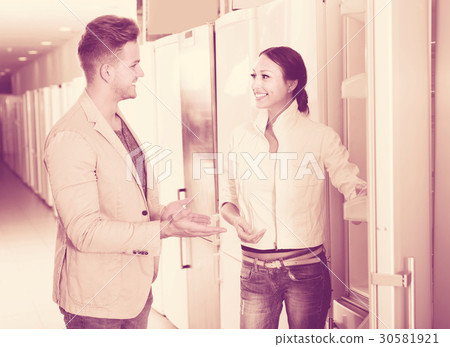 professional assistant in the shop sell a fridge to customer professional assistant in the shop sell a fridge to customer 30581921