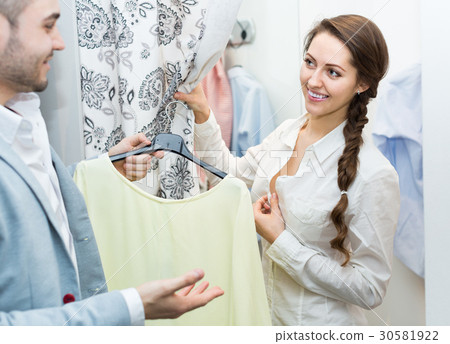 Young couple at fitting room. Young couple at fitting room. 30581922