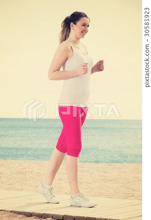 Woman running on beach Woman running on beach 30581923