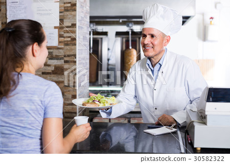 man chef giving order with kebab 30582322