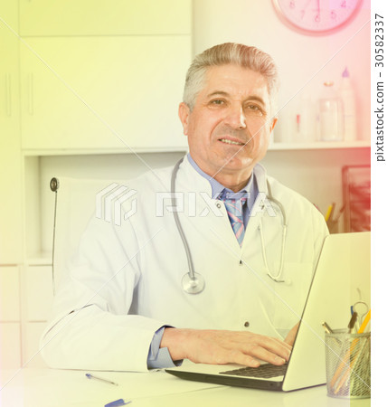 Mature doctor in his office Mature doctor in his office 30582337