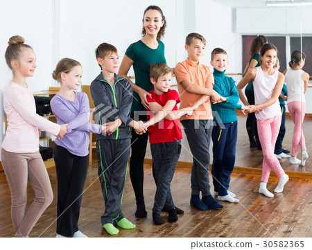 children studying folk style dance in class children studying folk style dance in class 30582365