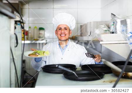 man with pans with kebab plate man with pans with kebab plate 30582427