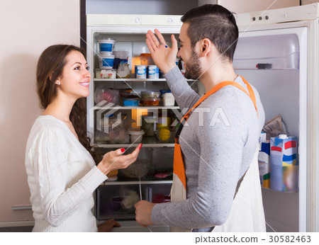 Client and repairman near fridge 30582463