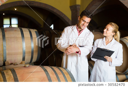 Friendly team of winery posing with wine 30582470