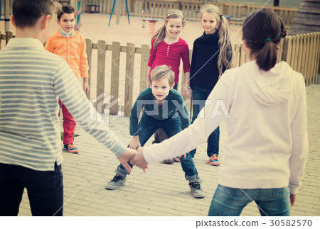 Group of ordinary children playing red rover Group of ordinary children playing red rover 30582570