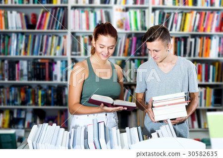 Girl and boy in book store Girl and boy in book store 30582635