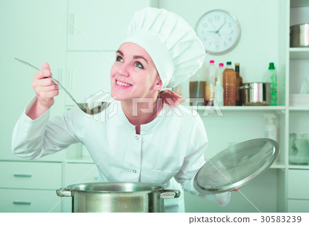 Female cook tasting food 30583239
