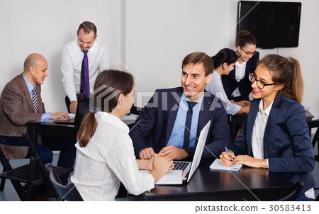 Coworkers working effectively on business project together 30583413