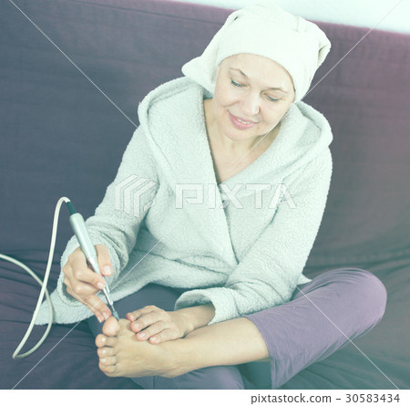 Woman doing pedicure Woman doing pedicure 30583434