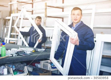 Young labour demonstrating PVC profiles Young labour demonstrating PVC profiles 30583958