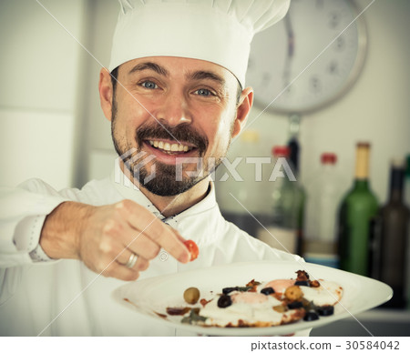 Male cook preparing food Male cook preparing food 30584042