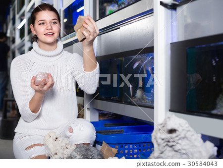 teenager selecting interesting aquarium rocks and stone for aquarium entourage teenager selecting interesting aquarium rocks and stone for aquarium entourage 30584043