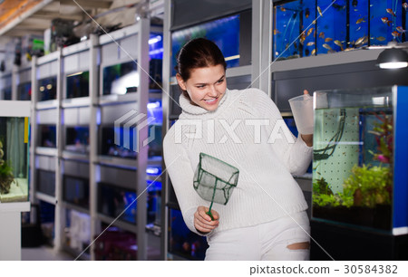 Teenager catch fry using a net and a bucket Teenager catch fry using a net and a bucket 30584382