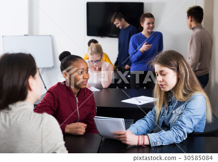 Girl consulting fellow student 30585084