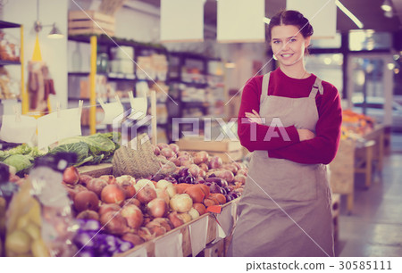 Young girl selling onion and smiling 30585111