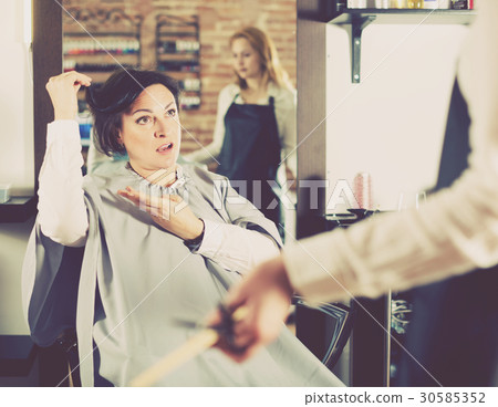 Upset woman in hairdress salon Upset woman in hairdress salon 30585352