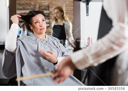 Ordinary woman is upset by her haircut 30585356