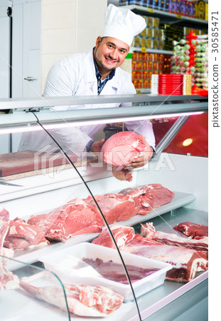 Male butcher in kosher section at supermarket Male butcher in kosher section at supermarket 30585471
