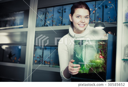 Girl stands near an aquarium Girl stands near an aquarium 30585652
