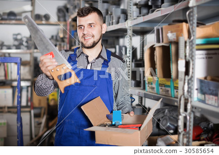 Professional builder man showing various tools Professional builder man showing various tools 30585654